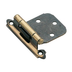 Item 207632, Face mount self-closing overlay hinge is finished in Antique brass and 